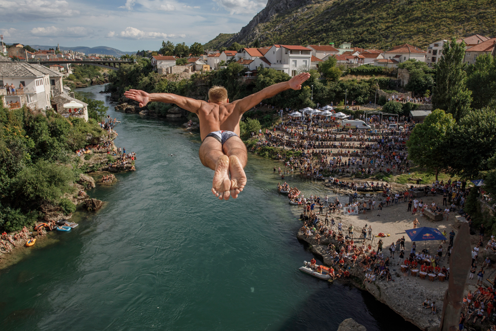 A competitor dives from Stari Most, also known as Old Bridge, on 26 July 2020, in Mostar, Bosnia and Herzegovina