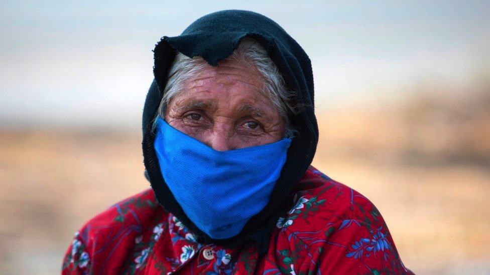 An elderly woman wears a face mask as a preventive measure against the spread of the new coronavirus, COVID-19 in Managua, Nicaragua.