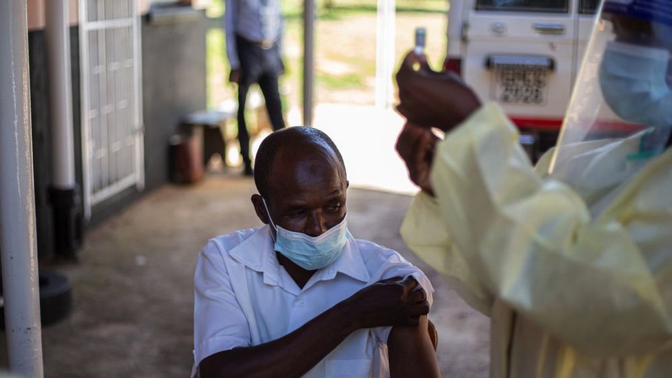 A nurse prepares to get the vaccine ata village clinic near Chinhoyi, Zimbabwe, February 2021