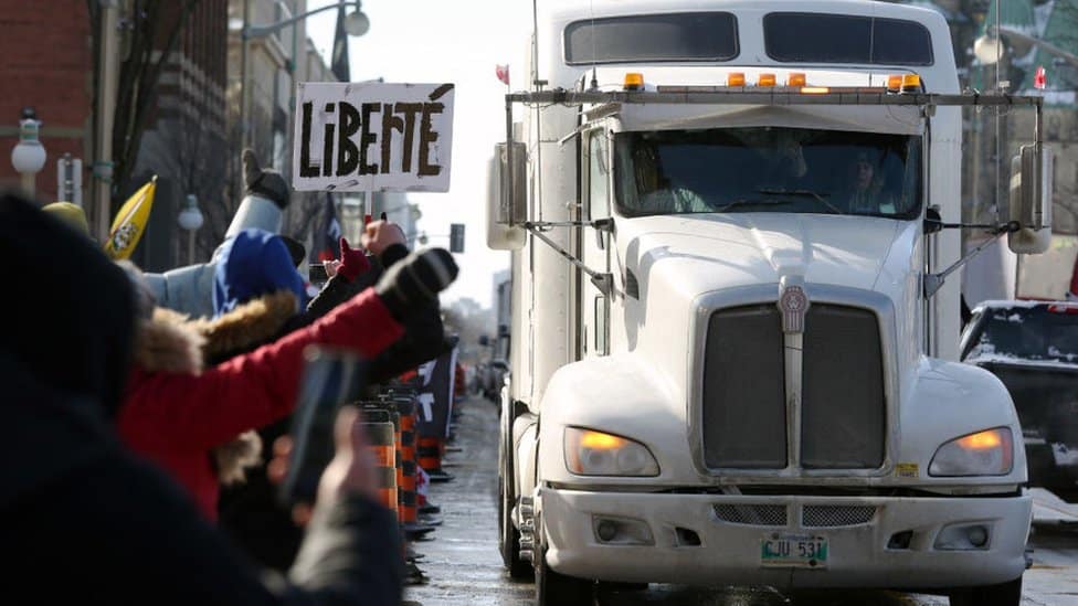 Supporters of the Freedom Convoy protest against Covid-19 vaccine mandates and restrictions in front of Parliament of Canada